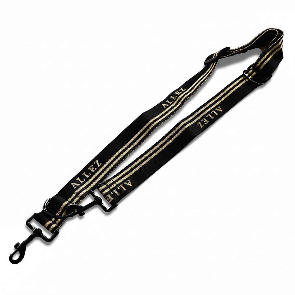 Black and white strap with 'ALLEZ branding on a white background. Thie shows the multi function adjustable dog lead . Like all Allez leads, this adventure series can be clipped on to an Allez belt for easy hands free dog walks.