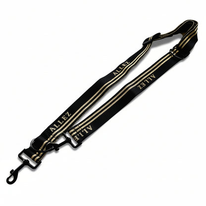 Black and white strap with 'ALLEZ branding on a white background. Thie shows the multi function adjustable dog lead . Like all Allez leads, this adventure series can be clipped on to an Allez belt for easy hands free dog walks.