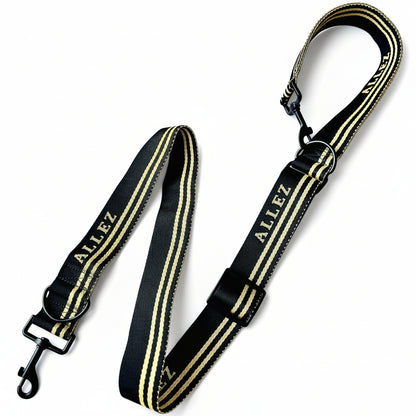 Black and gold striped dog leash with 'ALLEZ' branding on a white background